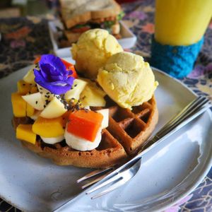 Gluten free waffle with fresh fruit and vegan mango ice cream. at Earth Tone in Pai