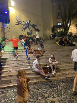 People dining outside on the stairs   at The Food Temple in Lisbon