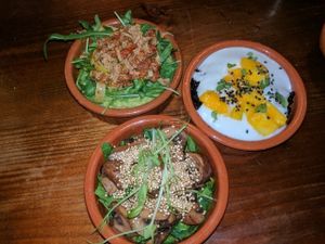 3 tapas of the day. pea puree with sundried tomatoes, black rice with coconut cream and mango, mushroom and quinoa salad.  at The Food Temple in Lisbon