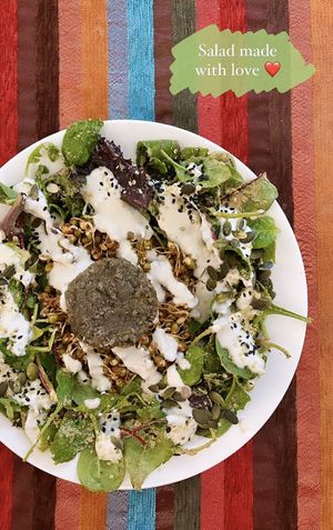 Salad with sunflower seed dressing, marinated mung and lentil sprouts + celery patty 💚  at Bliss Cafe in Stockholm