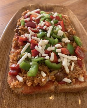 Vegan Pizza over ciabatta bread. with organic soy protein and vegan mozarella at Viva Chapata in Madrid