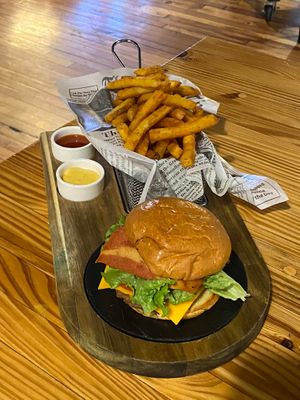 Organa Burger with vegan bacon added, and seasoned fries on the side. at Organa Food & Juice Bar in Troy