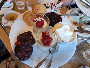 Afternoon tea: muffins with cherry jam and cream, lemon posset and rocky road bites at Ateneum Bistro in Helsinki