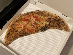 Calzone (stuffed with vegan mozzarella, deep-fried aubergines and mushrooms) and vegan margherita topped with friarielli, black olives and bell peppers   at Sacro Dough Pizza in North West London