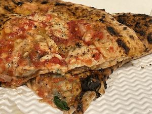 Calzone (stuffed with vegan mozzarella, deep-fried aubergines and mushrooms) and vegan margherita topped with friarielli, black olives and bell peppers   at Sacro Dough Pizza in North West London