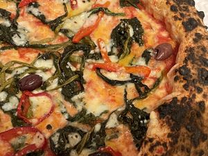 Calzone (stuffed with vegan mozzarella, deep-fried aubergines and mushrooms) and vegan margherita topped with friarielli, black olives and bell peppers   at Sacro Dough Pizza in North West London