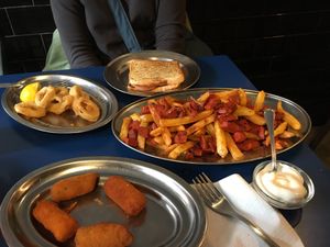 Calamari, sausage with French fries, croquettes, chorizo sandwich  at B13 Bar in Madrid