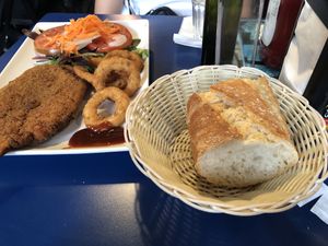 Seitan chicken burger with salad and onion rings at B13 Bar in Madrid