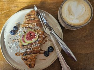Grilled croissant with almond butter topping  & oat latte 🥰 at Soul's in Dusseldorf