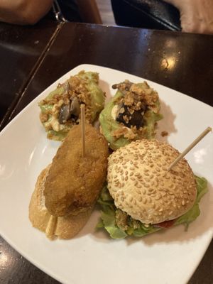 Pintxos veganos: guacamole, hummus, setas y cebolla frita; croqueta de setas; hamburguesa de quinoa  at La Muga in Bilbao