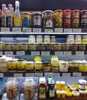 Variety of nut butters on second shelf from top at Bob's Red Mill in Tashkent