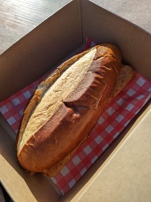 Pretzel bun with vegan sausage at The Lift Cafe in Folkestone