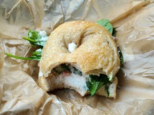 Salt bagel, vegan cc, greens, tomatoes, red onions, capers at Gemini Cafe & Bakery in Bethel