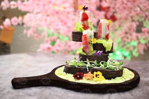 Fresh summer twist of fruits including strawberries and pineapple, wrapped with green local lettuce.  at Quynh House Vegetarian Dining in Ho Chi Minh City