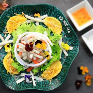 Lotus salad served with Mexico's crunchy taco - a fusion dish. Fresh lotus stem lies on a bed of salad, topped with house-made pickled veggies. Drizzle in our sour vegan fish.  at Quynh House Vegetarian Dining in Ho Chi Minh City