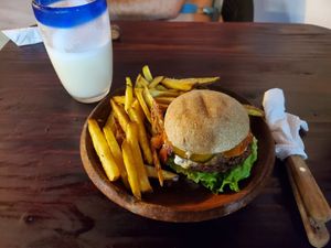 Quinoa burger with fries and coco pina juice at Bhakti House Ayampe  in Ayampe
