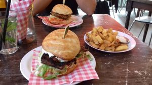 Tofu burger in the front, spicy chickpea burger in the back, with a side order of fries with vegan garlic mayonaise. at Burgertrut in Rotterdam