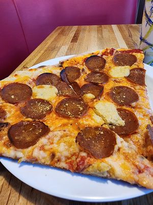 Vegan pepperoni by the slice! The wide angle on my camera makes them seem larger, but they're still a good size. at Pizza Jerk - SW in Portland
