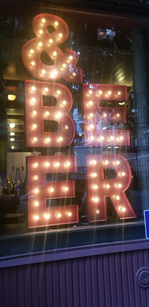 The only table seats 5 and 2 people sit in window trying not to lean back into this suspended sign but looks very cool from the outside! at Third Kingdom in New York City
