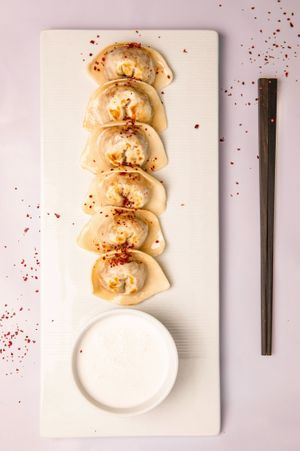 Vegan Non Chicken Gyoza.
Thin gyoza dough with vegan non-chicken served with vegan cream sauce and teriyaki sauce. Gyoza dough, vegan chicken, sesame, red pepper flakes at Dobro Top Vegan   in Dubai