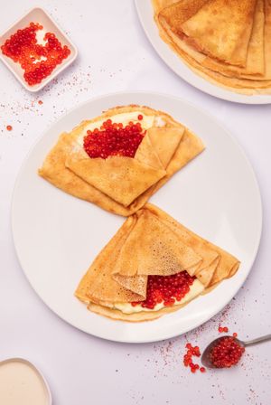Rice flour non-gluten crepes with vegan red caviar and cream-cheese. at Dobro Top Vegan   in Dubai