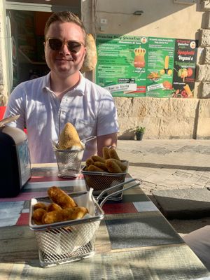 Tom is enjoying the street food!  at Vegan Food Tour Ortigia in Siracusa