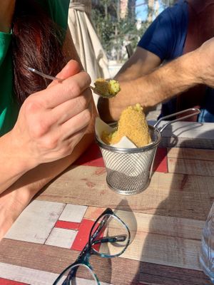 Paulina digging into her arancini at Vegan Food Tour Ortigia in Siracusa