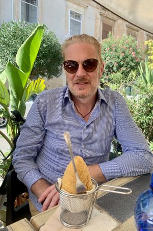 Sam getting ready to try the arancini at Vegan Food Tour Ortigia in Siracusa