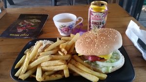 My vegan burger in a bun with salad, chips and coleslaw - drink was a fizzy ginger beer at George and Dragon in Salisbury