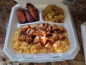 Yellow saffron rice with jerk jackfruit, plantains, and curried cabbage at Afrobites in Little Rock