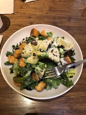 Caesar salad with lots of avocado and vegan parmesan  at Veggie Grill by Next Level - University Village in Seattle