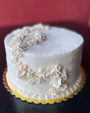 Beautiful v + gf wedding cake with rainbow colored (plant based chemical free colors) vanilla sponge and rosemary buttercream.   at Heart Baker - Cloud Kitchen in Buena Vista
