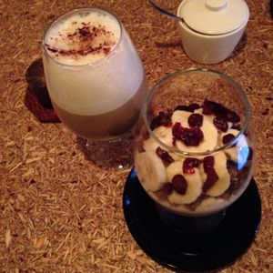 Millet dessert with banana and a cappuccino at Spoldzielnia Organic Bar in Krakow