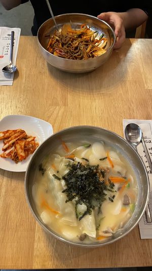 Buckwheat spicy noodles and rice cake dumpling soup with vegan kimchi  at Vegan Insa - 비건인사 in Seoul