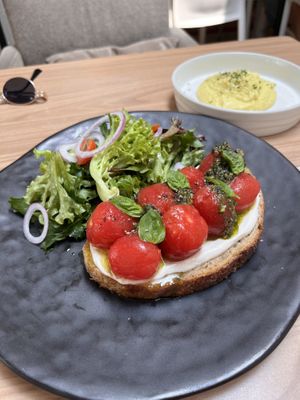 Confi tomatoes in sourdough toast, with pesto and cashews cream. Along with scrambled tofu   at Back to Eden in Central Singapore
