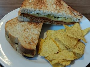 Sandwich with pastrami, cheese, mustard, and pickles at Harry's at 387 in Belfast