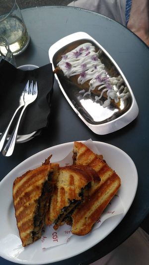 Top: potato omelette topped with aioli and edible flowers. Bottom: grilled toast filled with mushrooms, truffle and melted cheese. at COR in Zurich