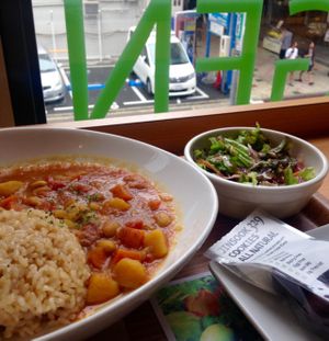 Vegetable curry with salad, and take - away cocoa cookies for later. at Genmai Cafe in Osaka
