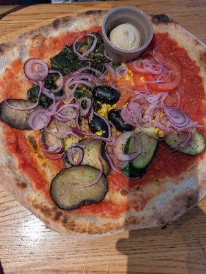 Vegan pizza with hummus dip at Martinerhof's Brauhotel in St Martin In Passeier