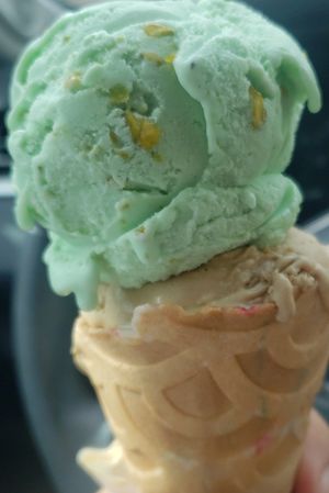 Coffee and pistachio ice cream with birthday cake cone 🍦 at Dreamboat Donuts & Scoops in Fort Worth
