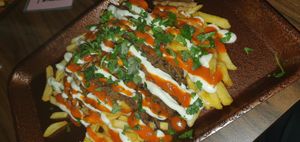 Doner loaded fries with cheese, chilli sauce and garlic sauce at The Flying Duck in Glasgow