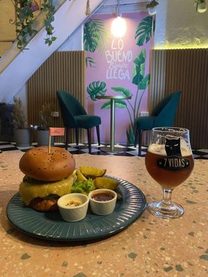 The Satiba house burger with lentil patty, and “not-cheese” served with side fries, paired with an American red ale beer.   at Satiba Therapy Coffee Shop in Arequipa
