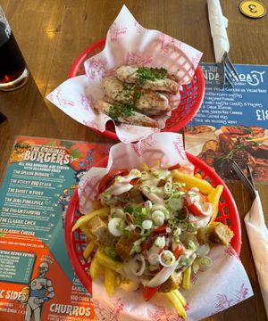 Top: garlic ch*cken strips
Bottom: loaded fries, garlic ch*cken, red peppers, and spring onions. at Junk Soul Smothered Bar & Grill in Beverley