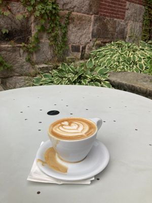 Oat milk latte, on outdoor table. at Revelstoke Coffee in Concord