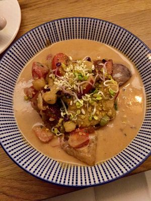 Pumpkin Curry with mushrooms, tomatoes, red onions and sprouts  at Gratitude Restaurant in Munich