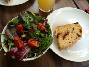 Lunch menu: side salad and bread with huge dried tomato chunks! Yum! at Gratitude Restaurant in Munich