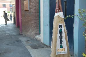Outdoor sign at Natura Cafe in South East London