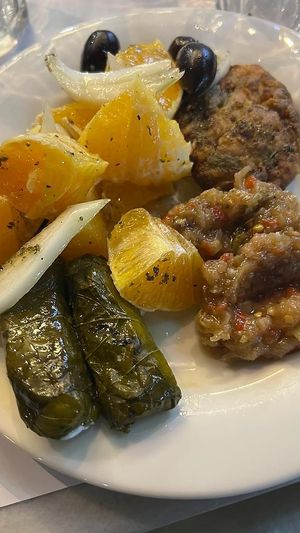 Stuffed vine leaves, orange salad, zucchini balls and eggplant salad  at To Steki sti Gonia in Himare