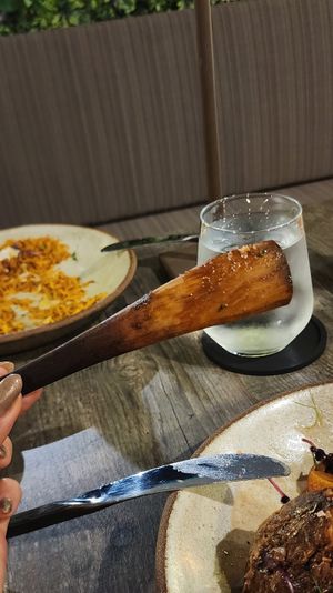 The wood holding the "lamb" made of seitan and jackfruit together at Petiole Cafe in Janabiyah