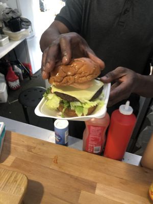 Pictured is the owner assembling the burger   at Fed By Plants in South East London